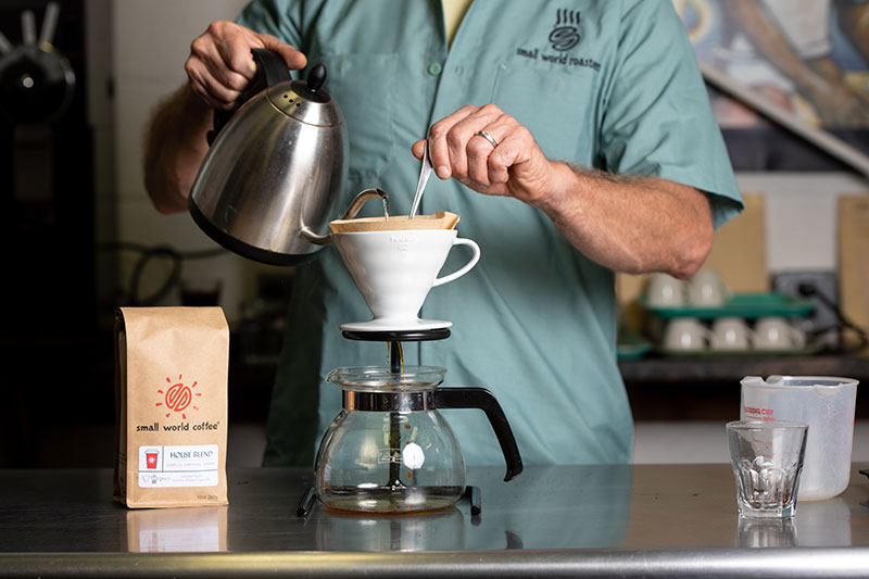 Take one “pass” with roughly 2-3 ounces of water of off-boil water over your grounds, and draw the spoon upwards through the grinds.